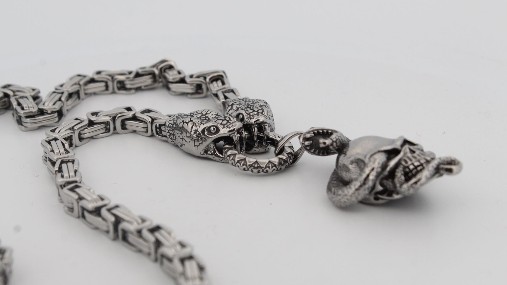 TWIN SERPENTS AND SKULL