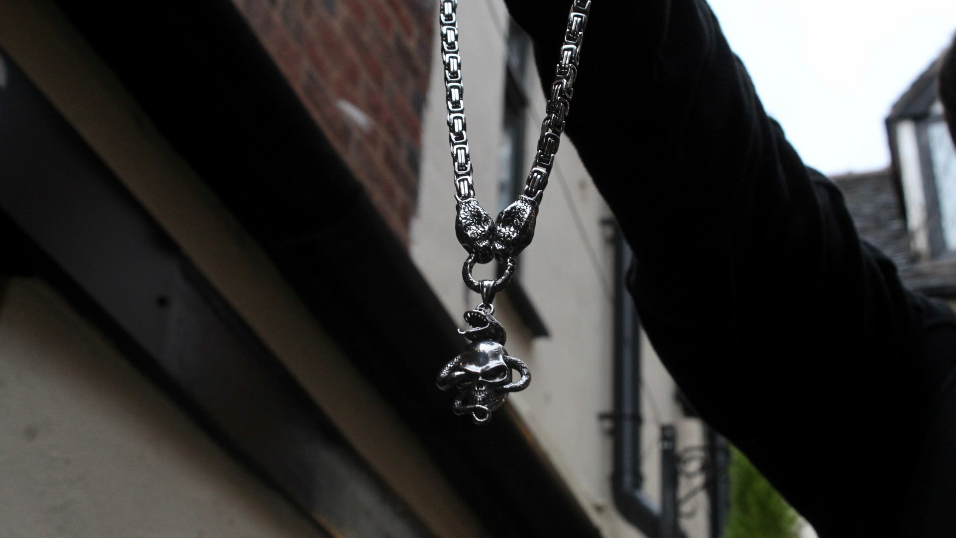 TWIN SERPENTS AND SKULL